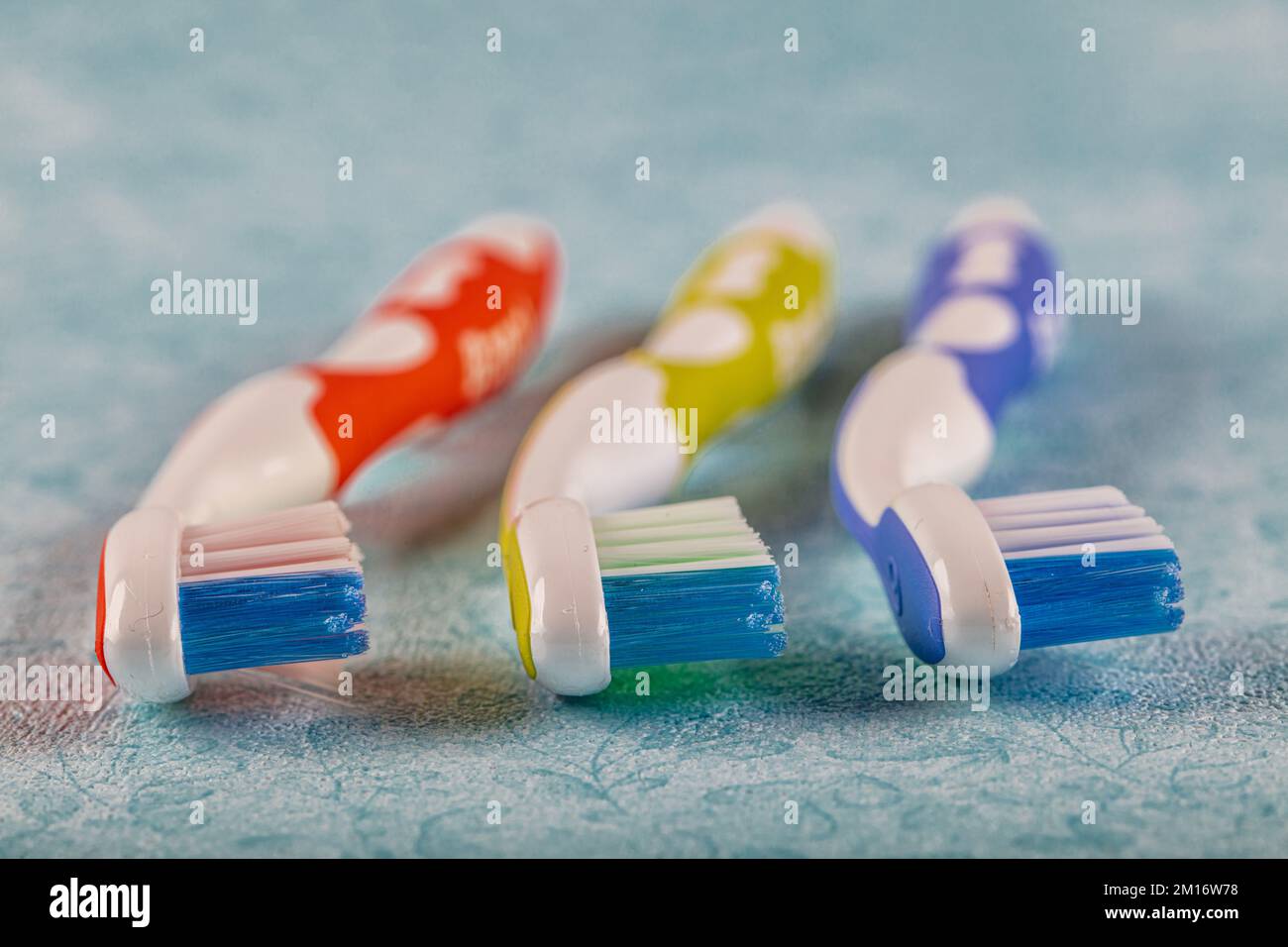 Plastic toothbrushes on the color background Stock Photo - Alamy