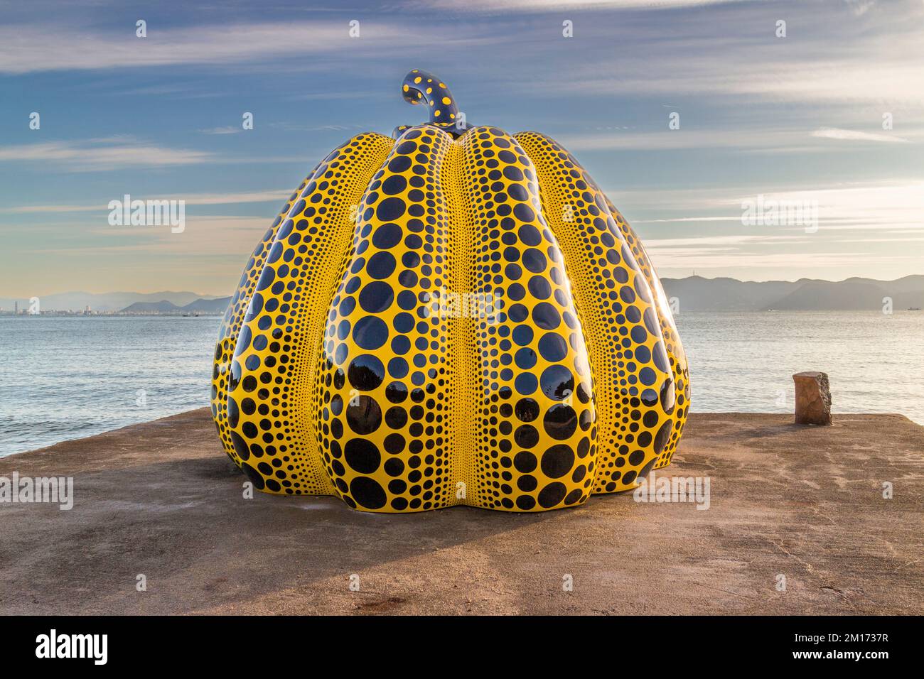 Yellow Pumpkin by Yayoi Kusama. The famous yellow pumpkin was swept into the sea by a typhoon in 2021. In 2022 a new specimen was erected in the same place. Naoshima, Japan Stock Photo