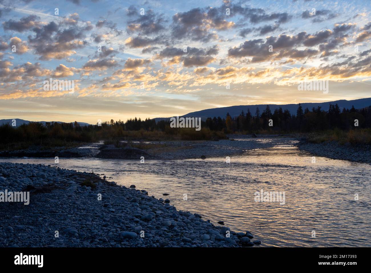 The Gros Ventre River winding through a braided network of river rocks below sunrise. Grand Teton National Park, Wyoming Stock Photo