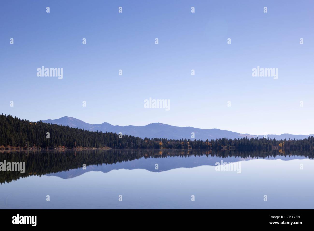 A completely calm Phelps Lake reflecting a clear sky. Grand Teton National Park, Wyoming Stock Photo