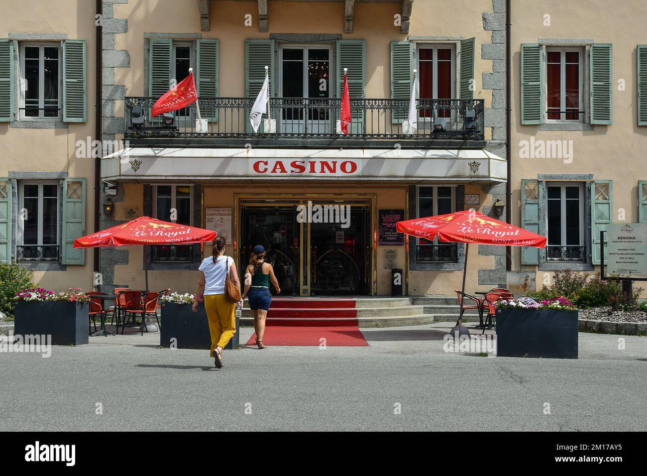 Two women entering in the Casino Le Royal in the alpine town, famous ski resort, in summer, Chamonix, Haute Savoie, France Stock Photo