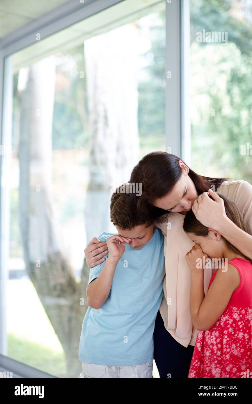 Grieving as a family. Shot of a family supporting each other in their grief. Stock Photo