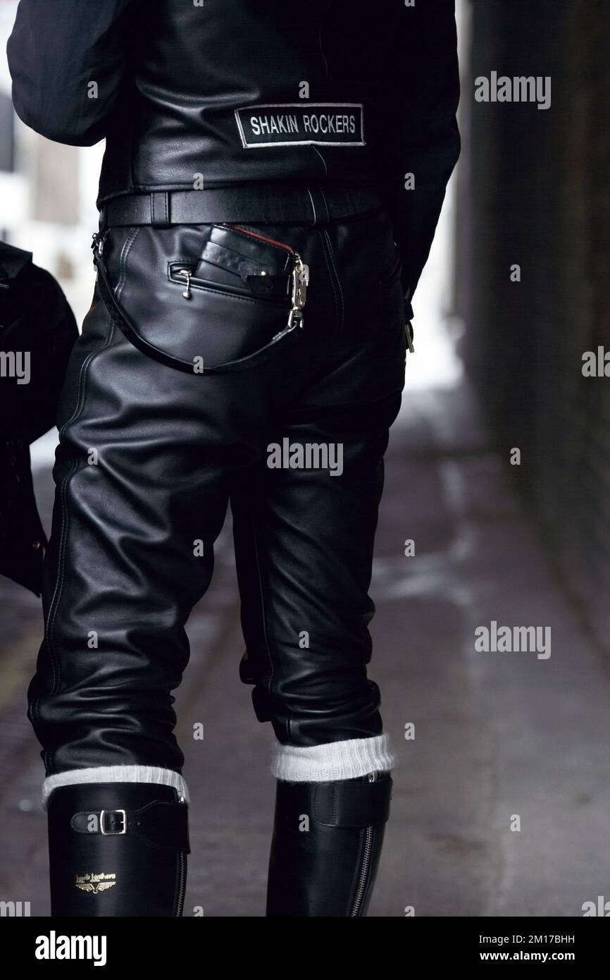 Closeup of leather pants with wallet and metal chain . Stock Photo