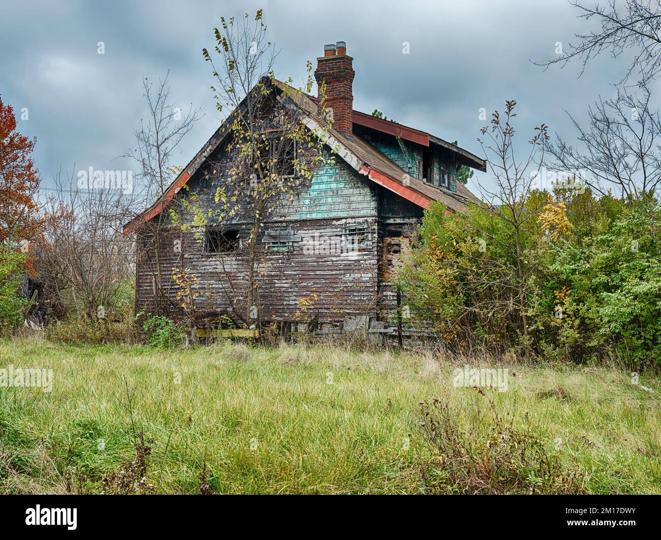 An empty lot sits in front of a burned house that was a victim of arson
