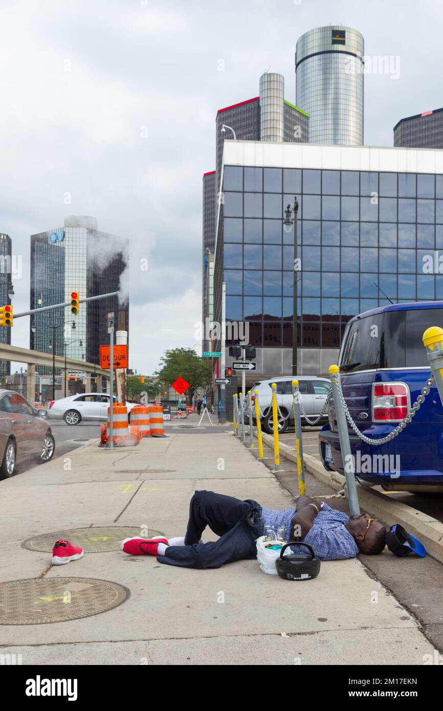 A man with beers and a ghettoblaster sleeping on the sidewalk Beaubien