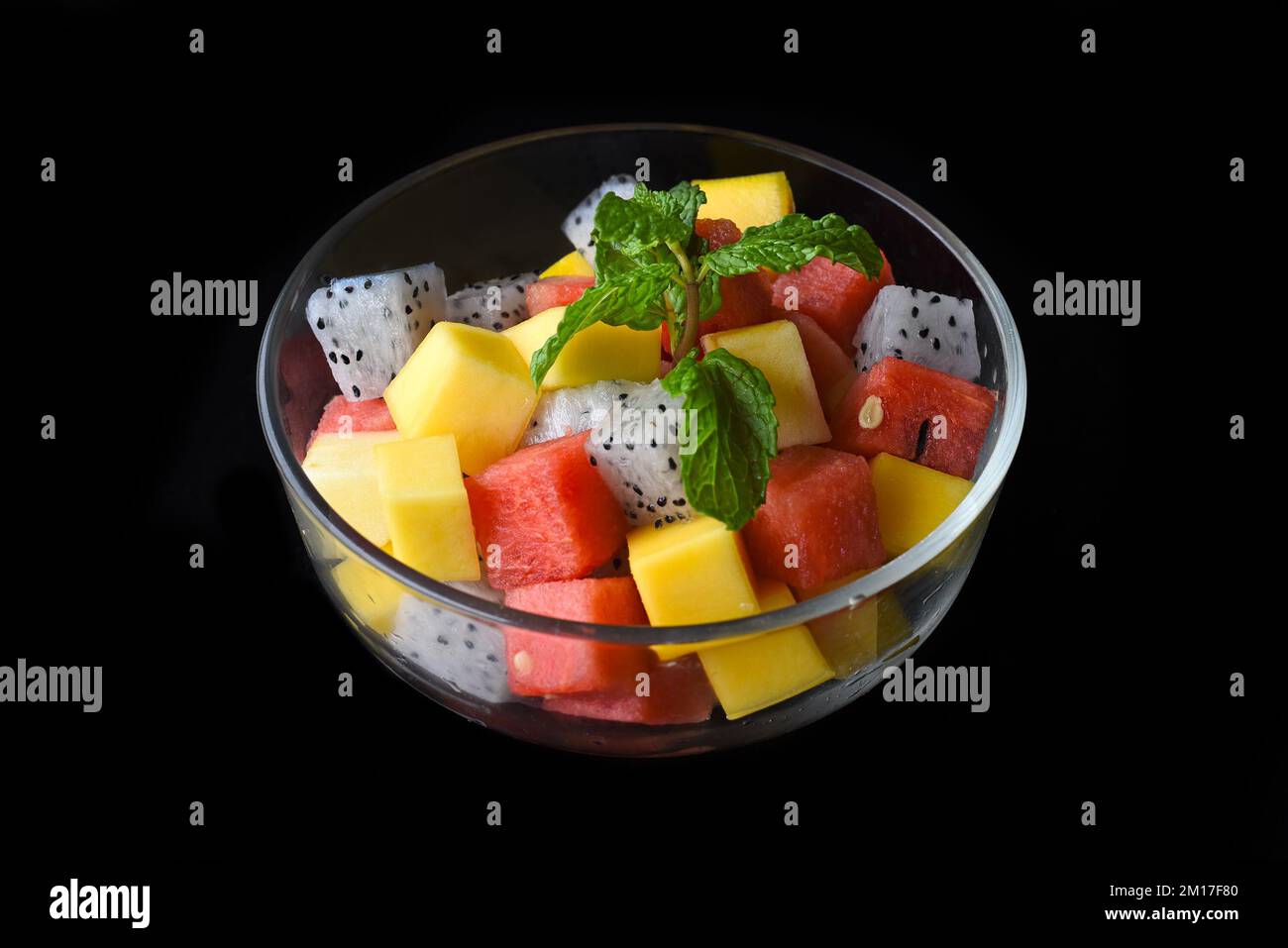 Fruit salad made of east asian fruits isolated on black background top view Stock Photo