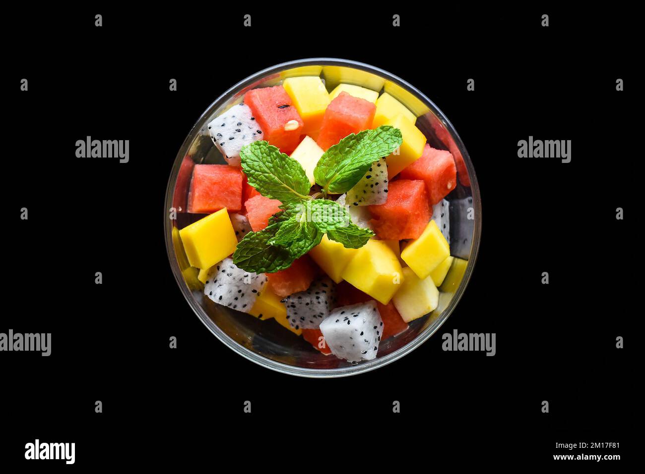 Fruit salad made of east asian fruits isolated on black background top view Stock Photo