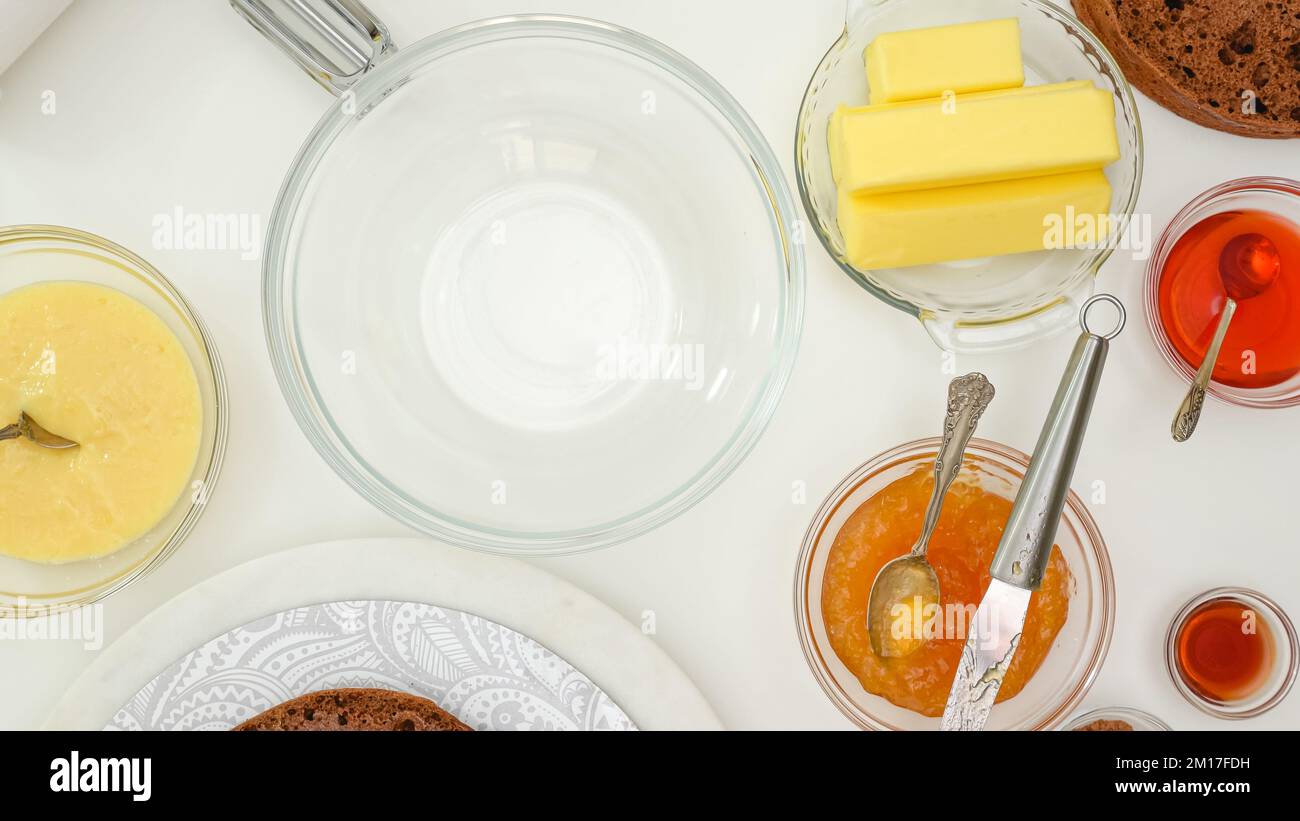 Baking process. Making butter cream for chocolate cake recipe. Ingredients for cream close upon kitchen table, flat lay Stock Photo