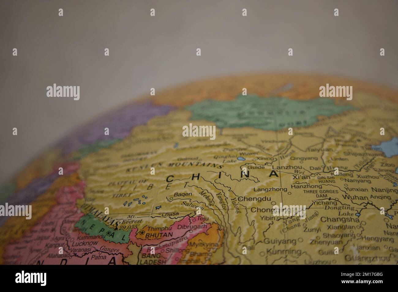 Close up of China on a globe, with other surrounding countries noted on the map, such as Bhutan and Nepal. Stock Photo