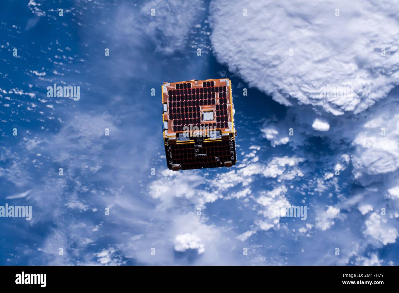 Small Satellite orbiting outer space above earth deployed by the international space station. Digitally enhanced. Elements of image furnished by NASA Stock Photo