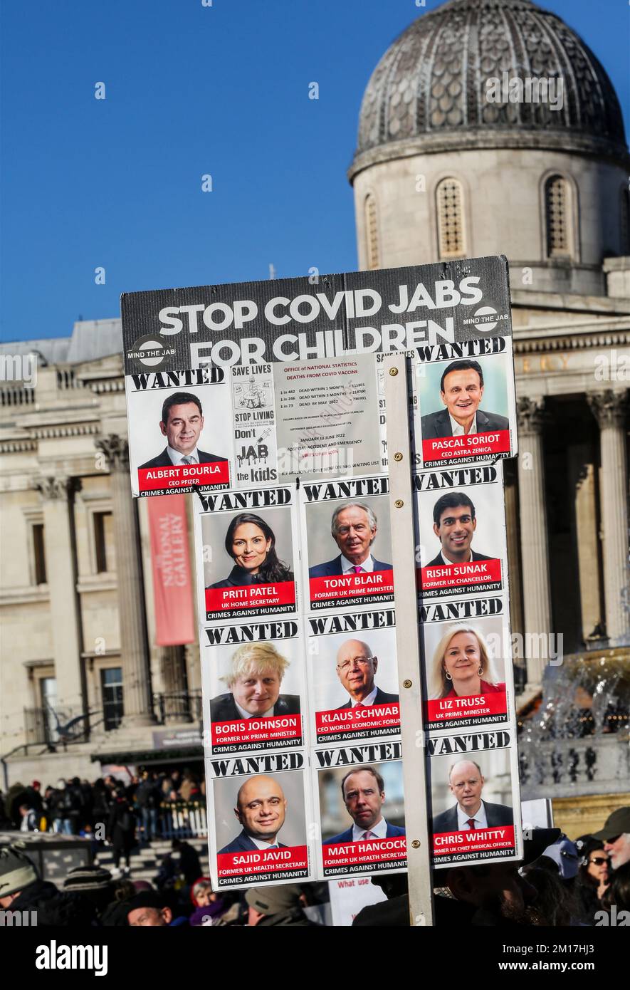 London, UK. 10th Dec, 2022. A protester holds a placard showing Wanted senior politicians and influential people, for their role during the covid years. Protesters came together and marched in Central London carrying boards and signs against the government and other ‘elites' that they believe are in the process of enslaving them. They are protesting against digital ID, a digital currency, 15 minute cities, Net Zero and the threat of climate lockdowns. Credit: SOPA Images Limited/Alamy Live News Stock Photo