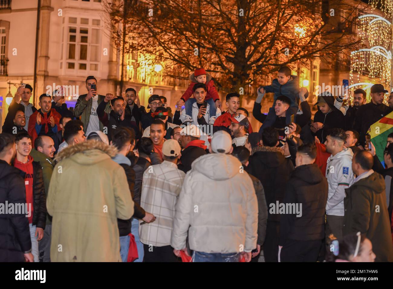 the moroccan people celebrate their victory in the world cup all over spain, in the picture a crowd of people celebrating in the main square of lugo t Stock Photo