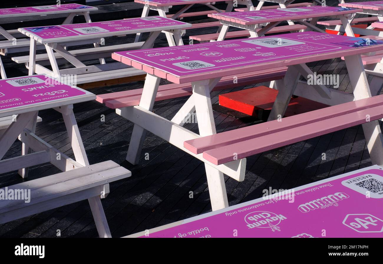 Pattern of bright pink tables at Barserve Pop Up Event on South Bank of Thames in London, England; Riverside Terrace Miami, Summer by the River Stock Photo