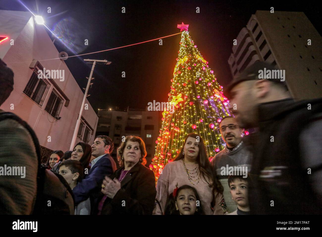 Gaza, Palestine. 10th Dec, 2022. Palestinians attend a Christmas tree lighting ceremony in Gaza City. The event was organized by the non-governmental organization NGO Young Men's Christian Association (YMCA). Credit: SOPA Images Limited/Alamy Live News Stock Photo