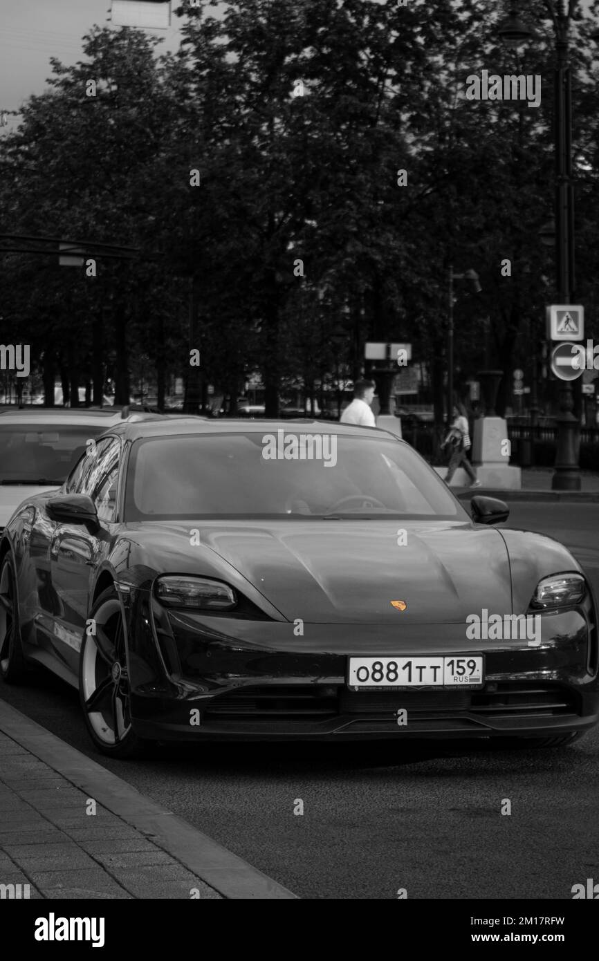 A vertical of Porsche parked on the street shot in grayscale Stock ...