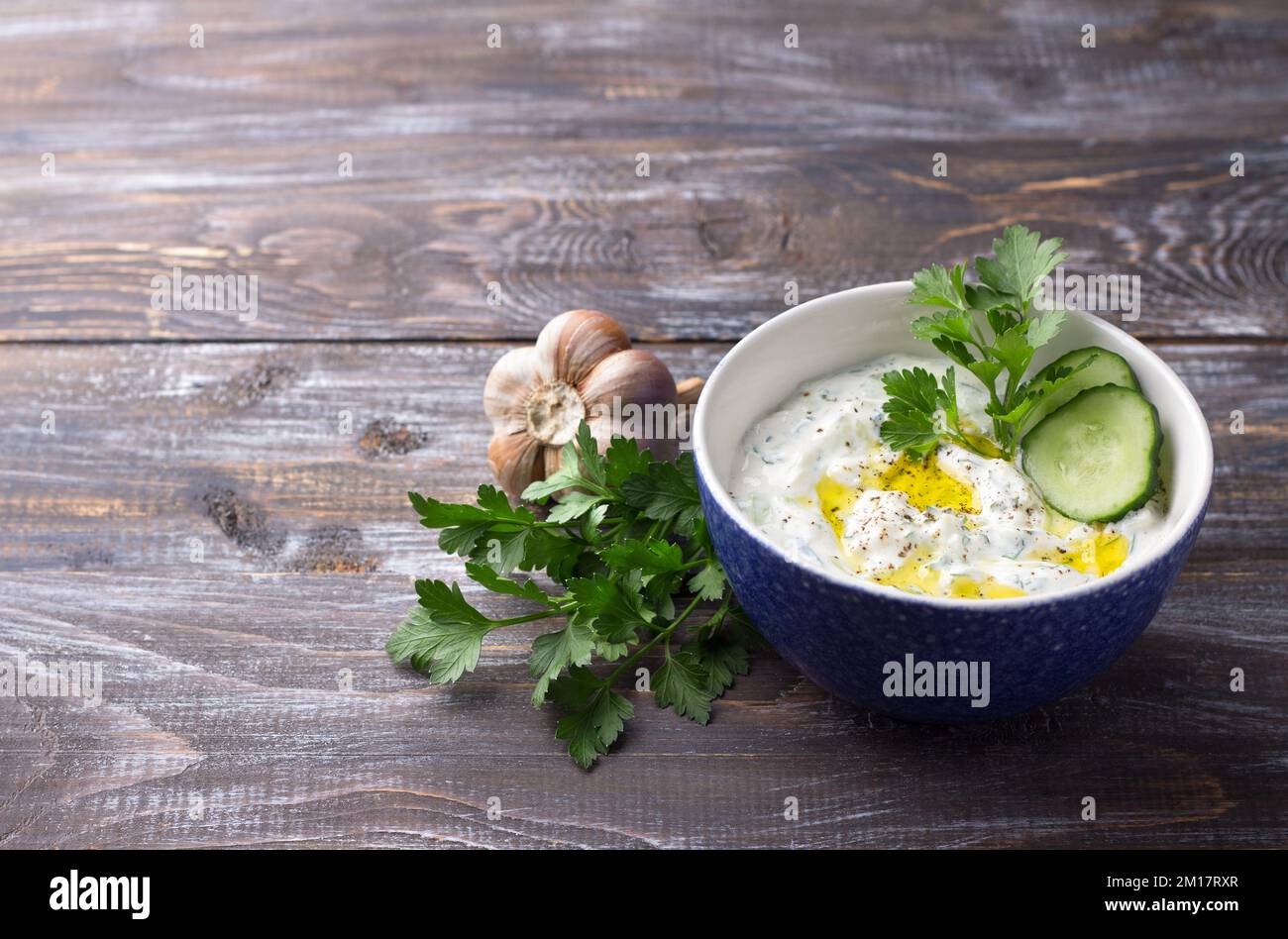 Traditional greek yogurt tzatziki sauce with cucumbers and herbs on