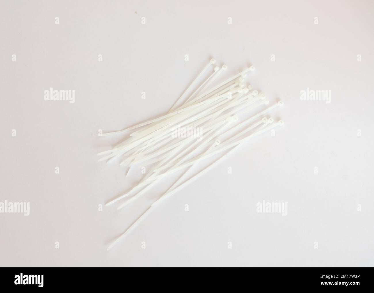 White plastic ties on white isolated background Stock Photo