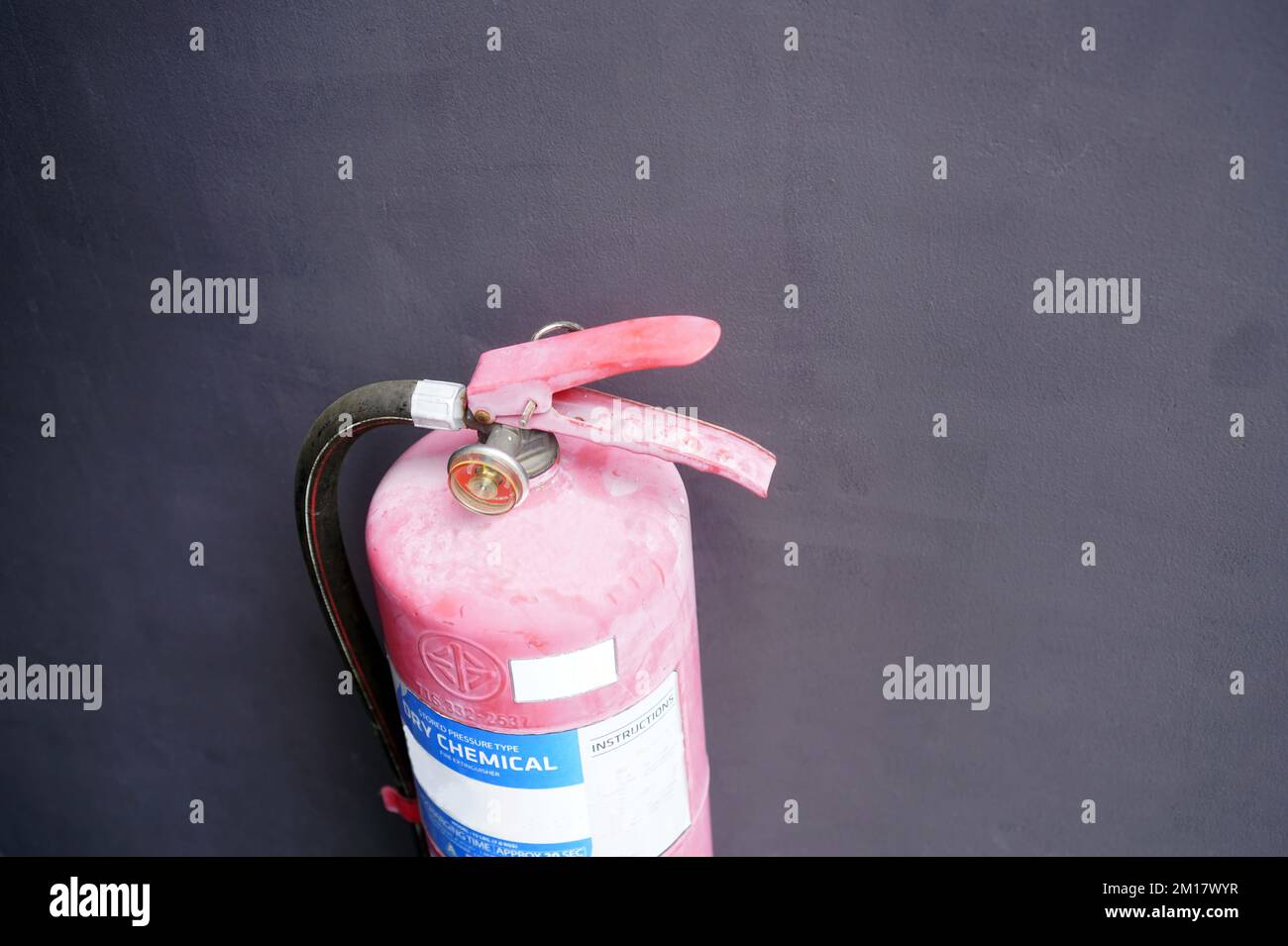 A old fire extinguishers install on the cement wall Stock Photo Alamy