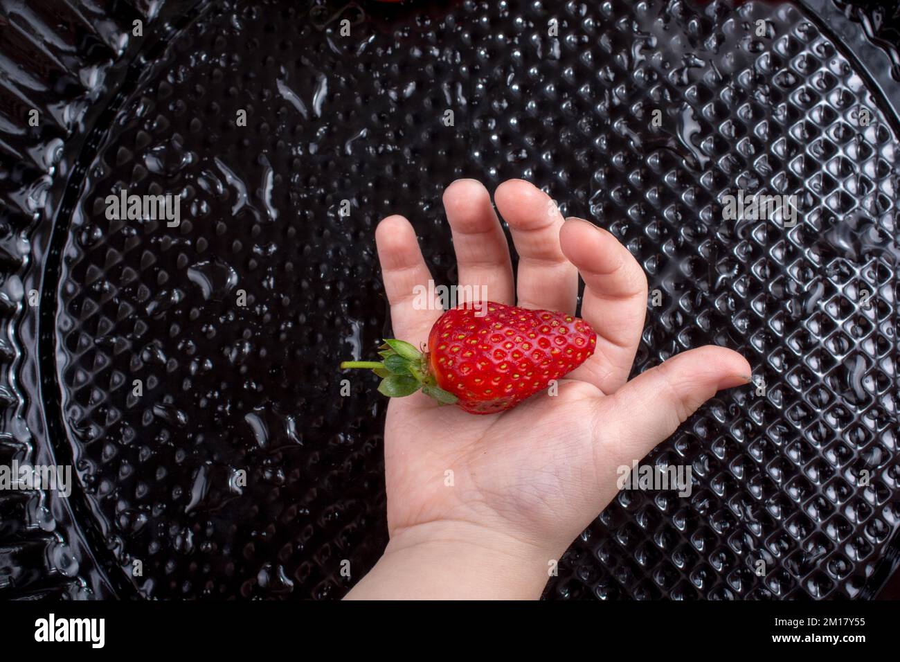 Juicy, sweet and ripe strawberry fruit in hand Stock Photo - Alamy