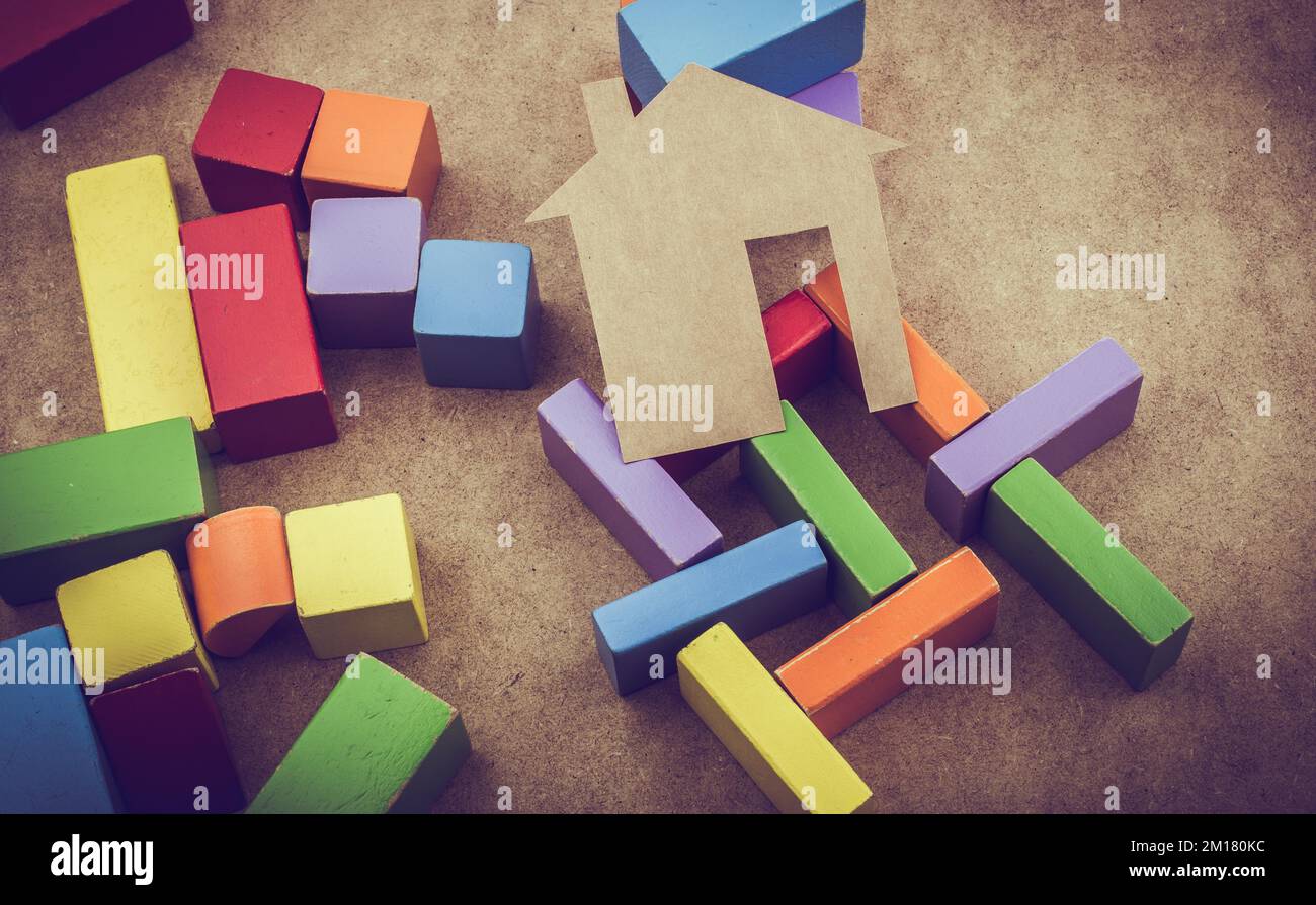 House shape formed out of building blocks on a brown background Stock ...