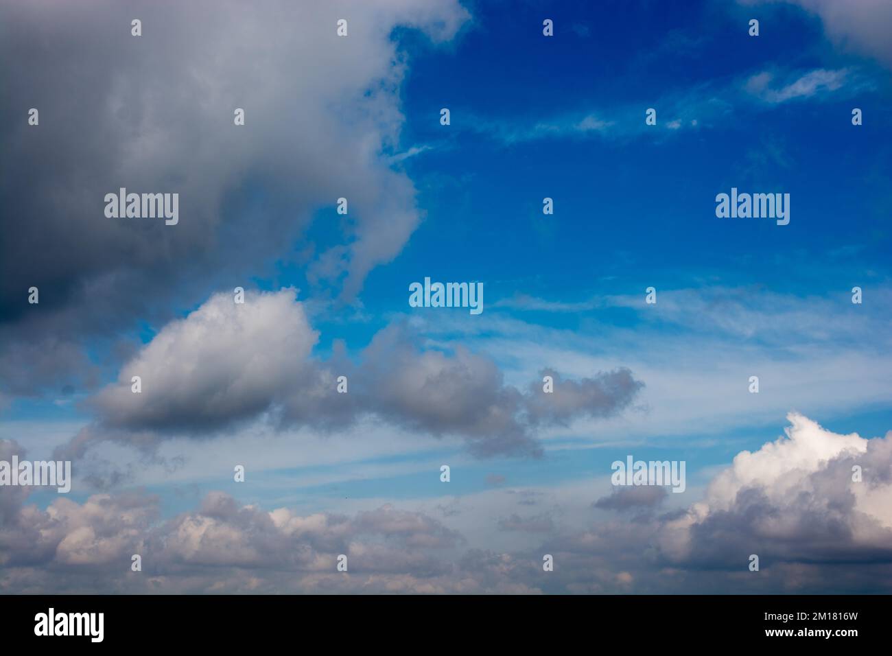 Blue cloudy sky with white and grey clouds Stock Photo - Alamy