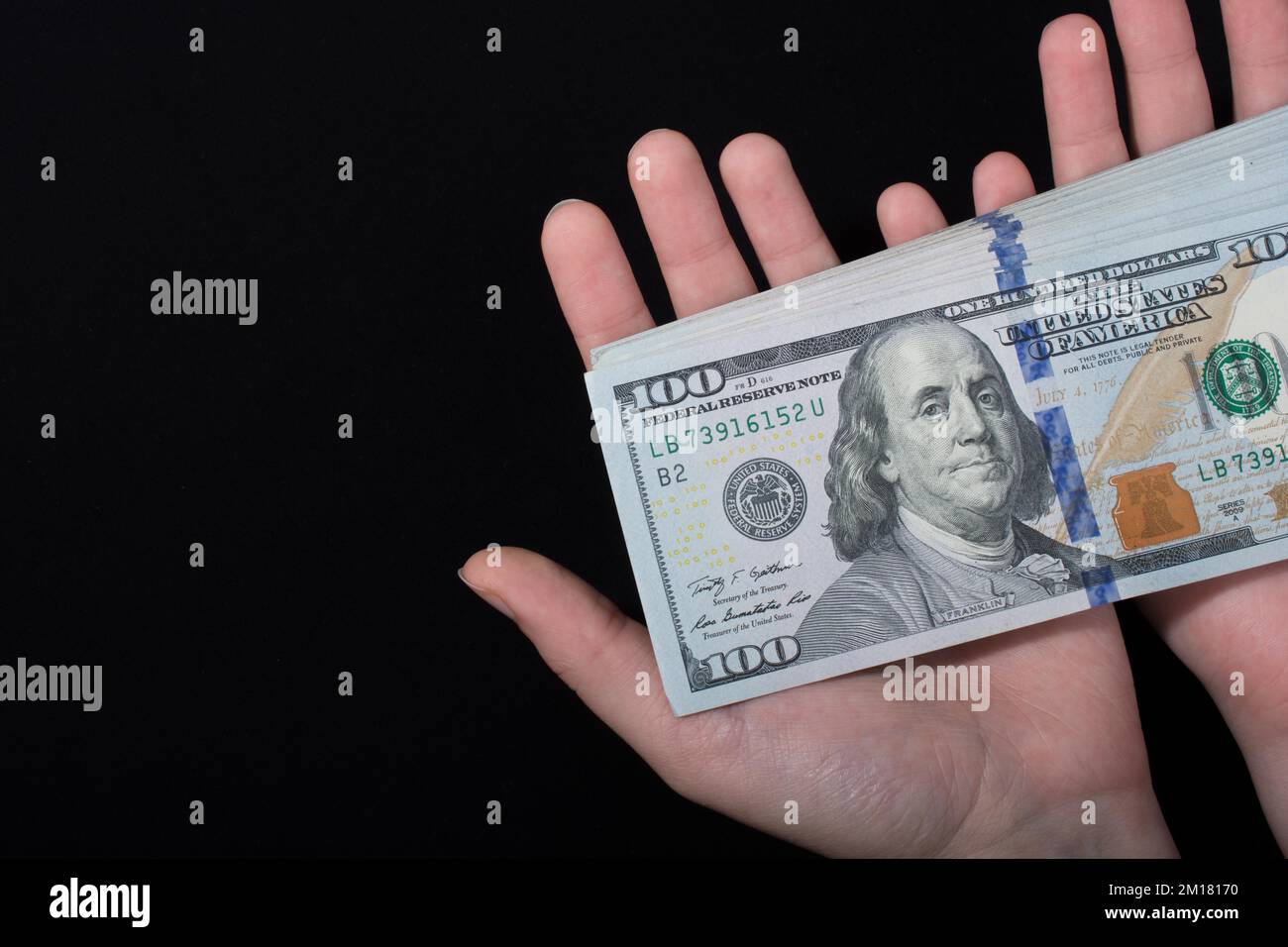 Hand holding American dollar banknotes isolated on white background ...
