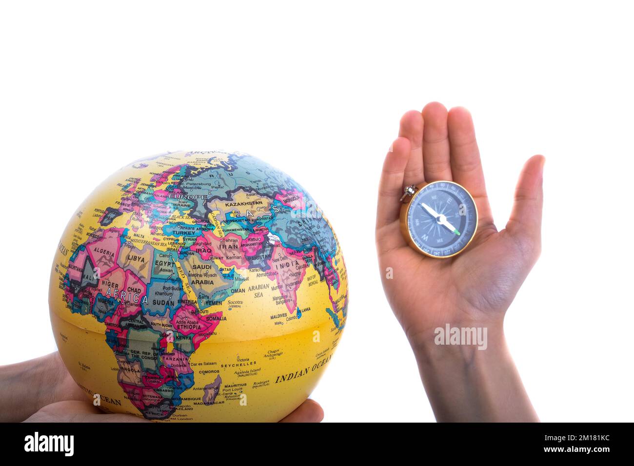 Globe and compass in hand on white background Stock Photo