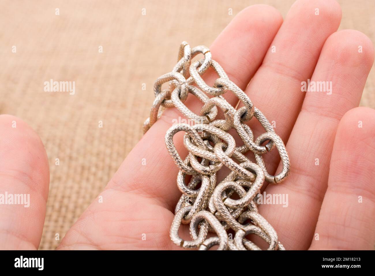 Chain made of gold color in hand Stock Photo Alamy