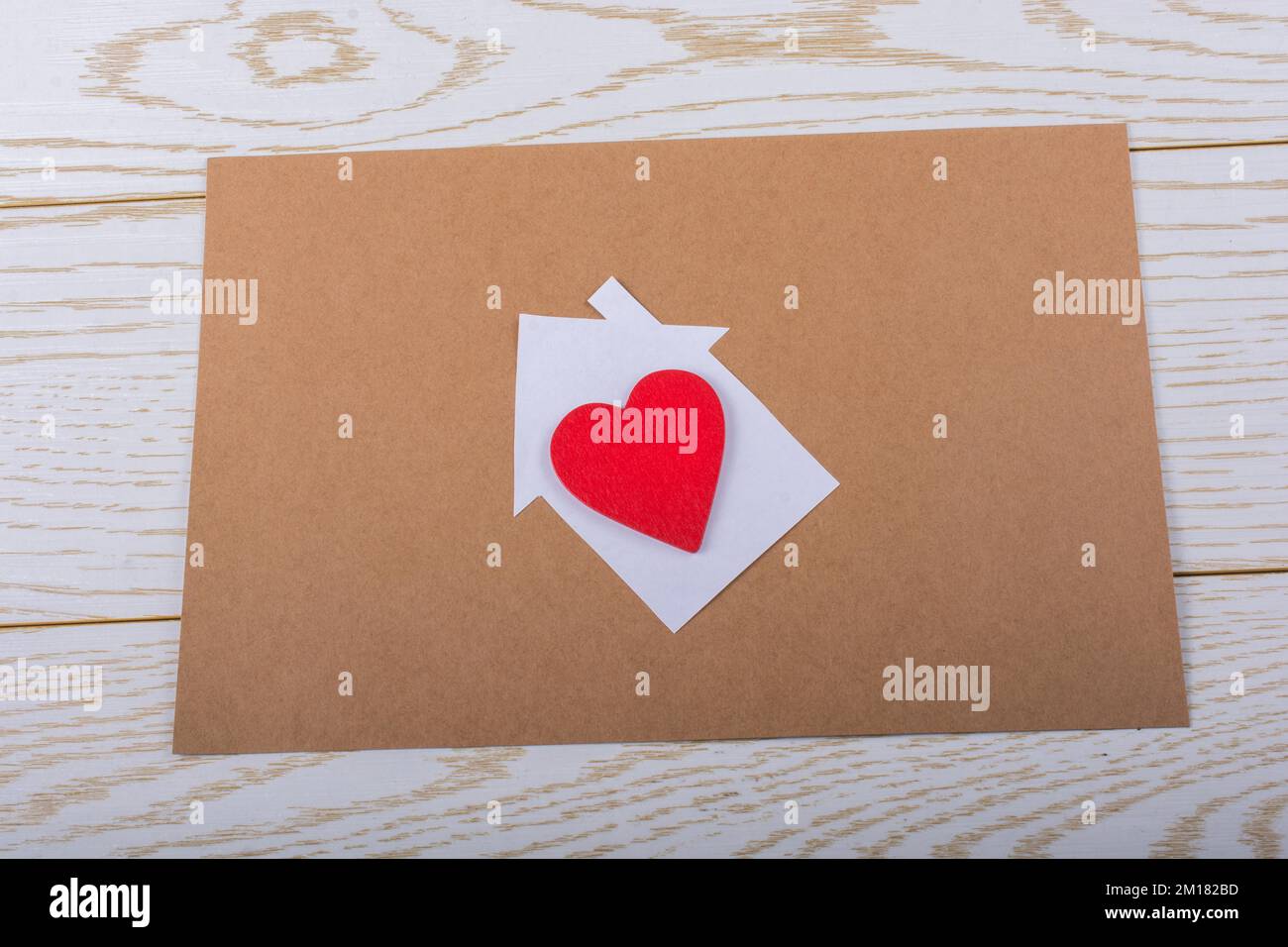 Little paper house and a heart in view Stock Photo - Alamy