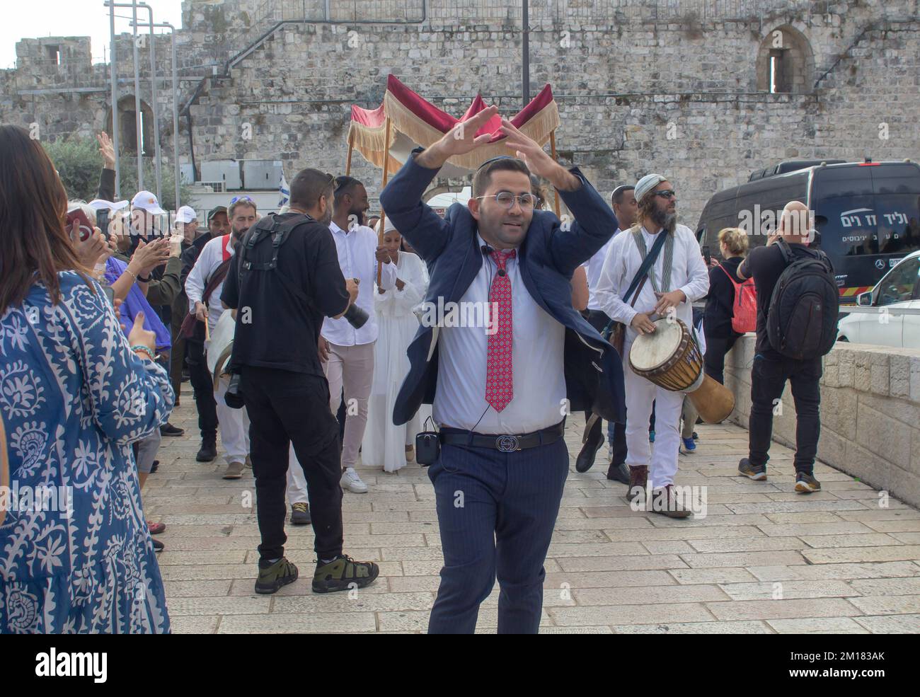 10 Nov 2022 A Rabbi leading family and friends at a Bar Mitzvah celebration near the Jaffa Gate as the party makes its way to the Western Wall and the Stock Photo