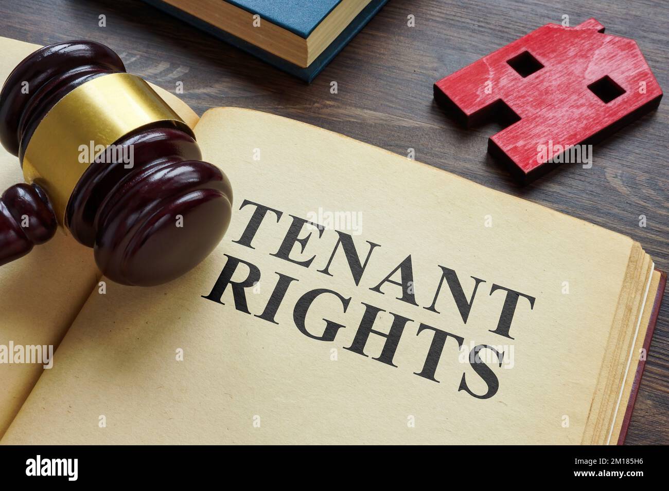 Book about Tenant rights and model of house. Stock Photo