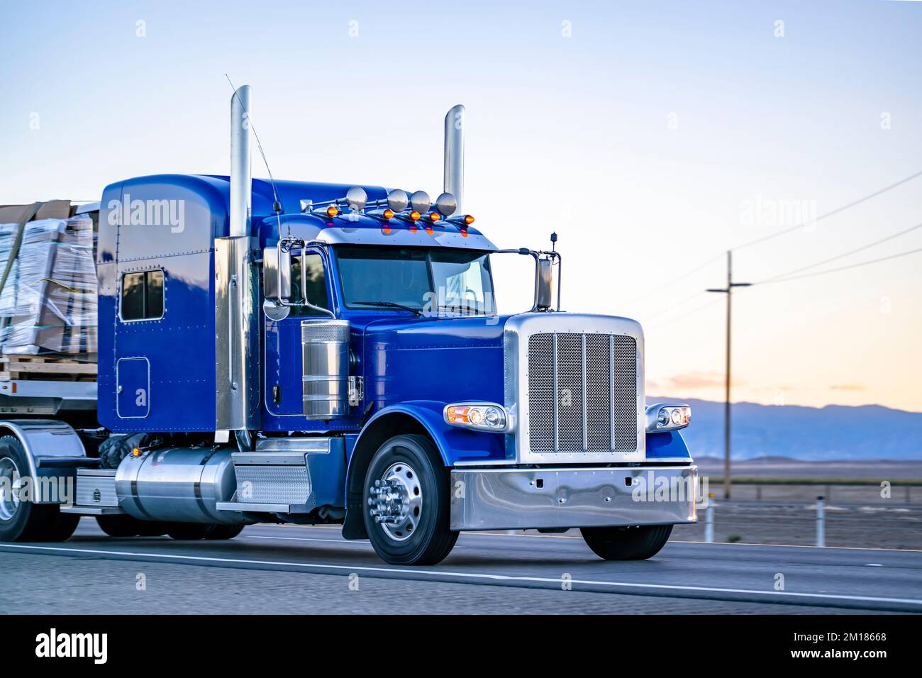 Industrial long hauler big rig blue semi truck with chrome parts