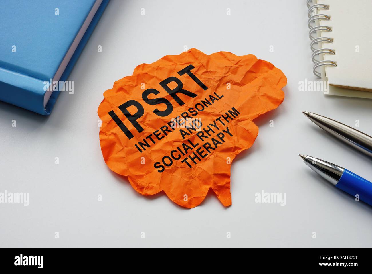 Paper brain with inscription Interpersonal and Social Rhythm Therapy IPSRT. Stock Photo