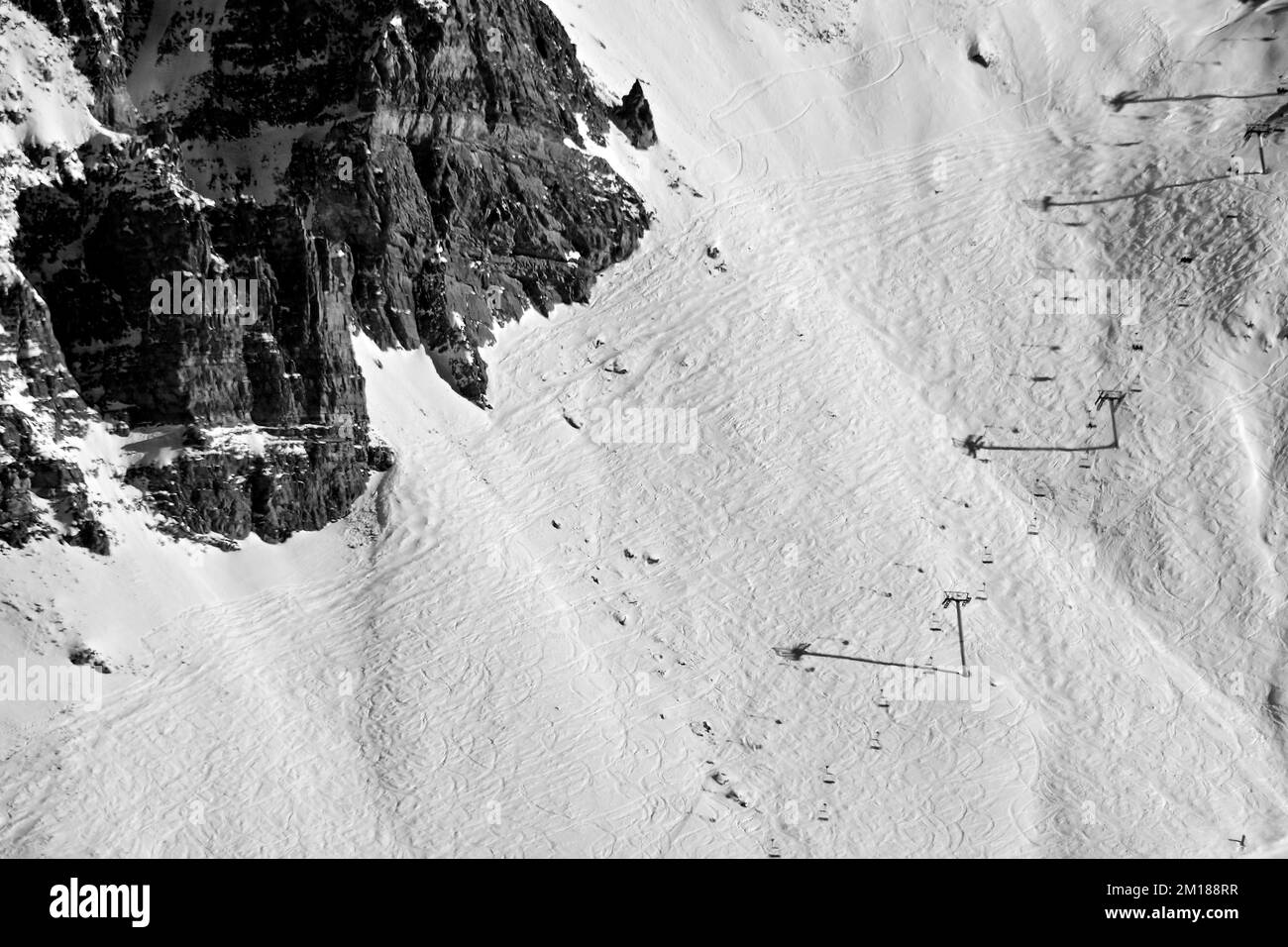 A grayscale of snowy ski lifts of the French Alps Stock Photo - Alamy