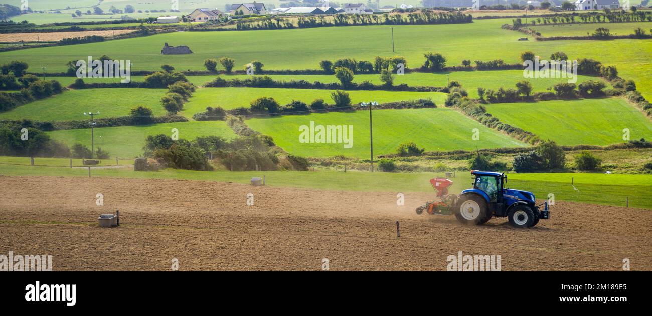 County Cork, Ireland, August 20, 2022. A tractor sows a plowed field on