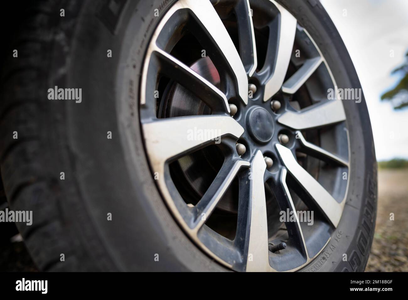 woman changing a tyre in the country. girl mechanic changing a tire in