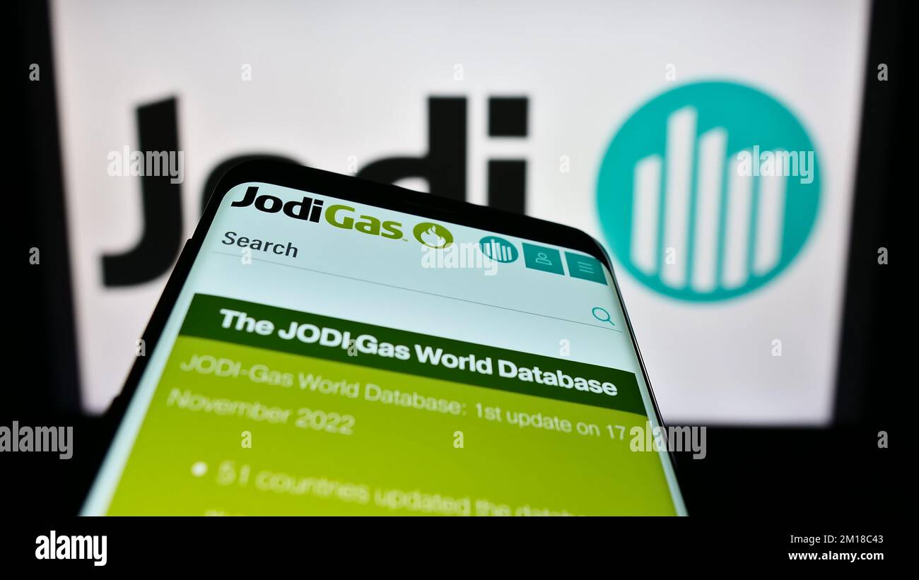 Mobile phone with webpage of Joint Organisations Data Initiative (JODI) on screen in front of logo. Focus on top-left of phone display. Stock Photo