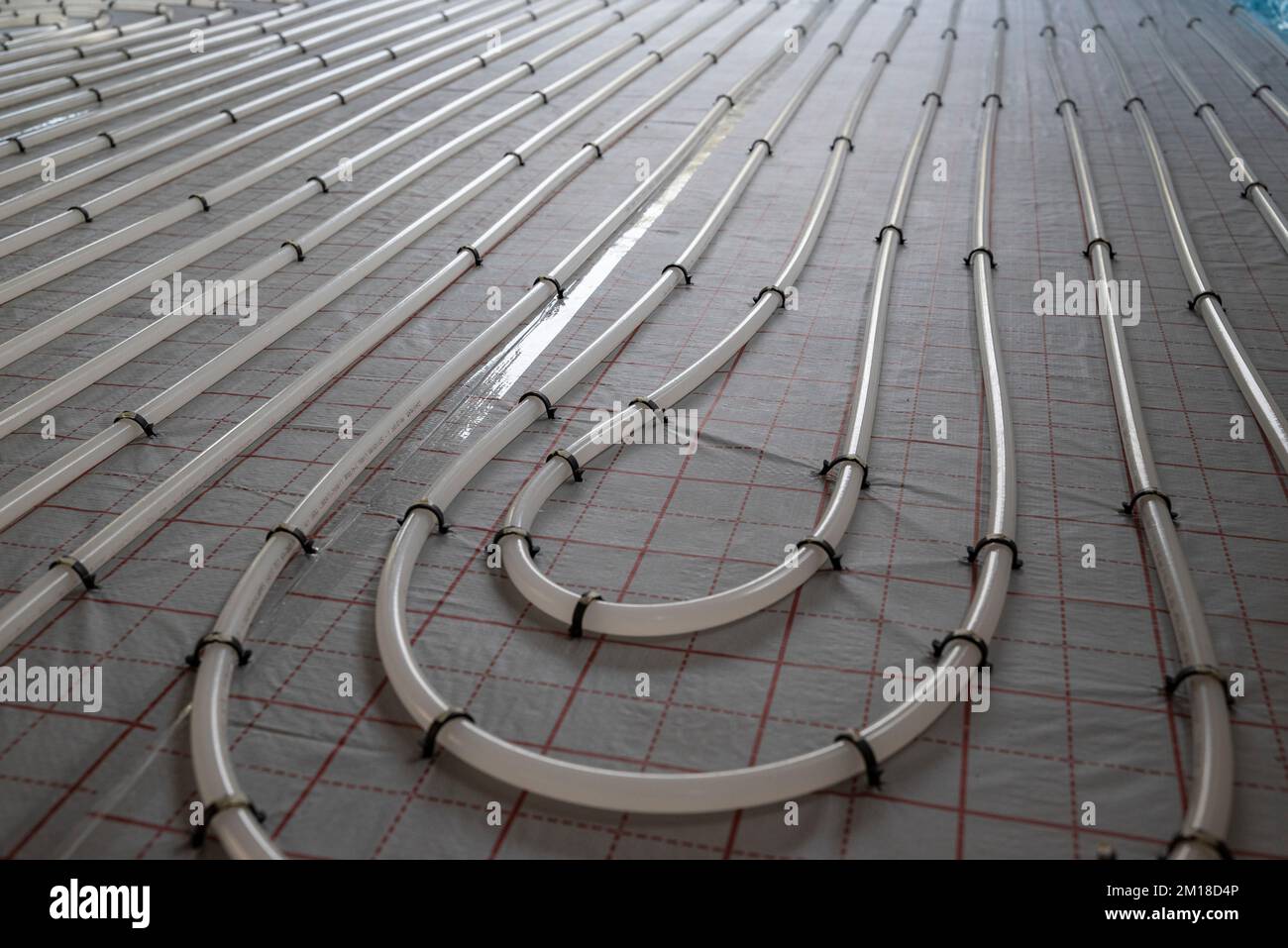 The winding tubes of the hydronic radiant heating system on the floor