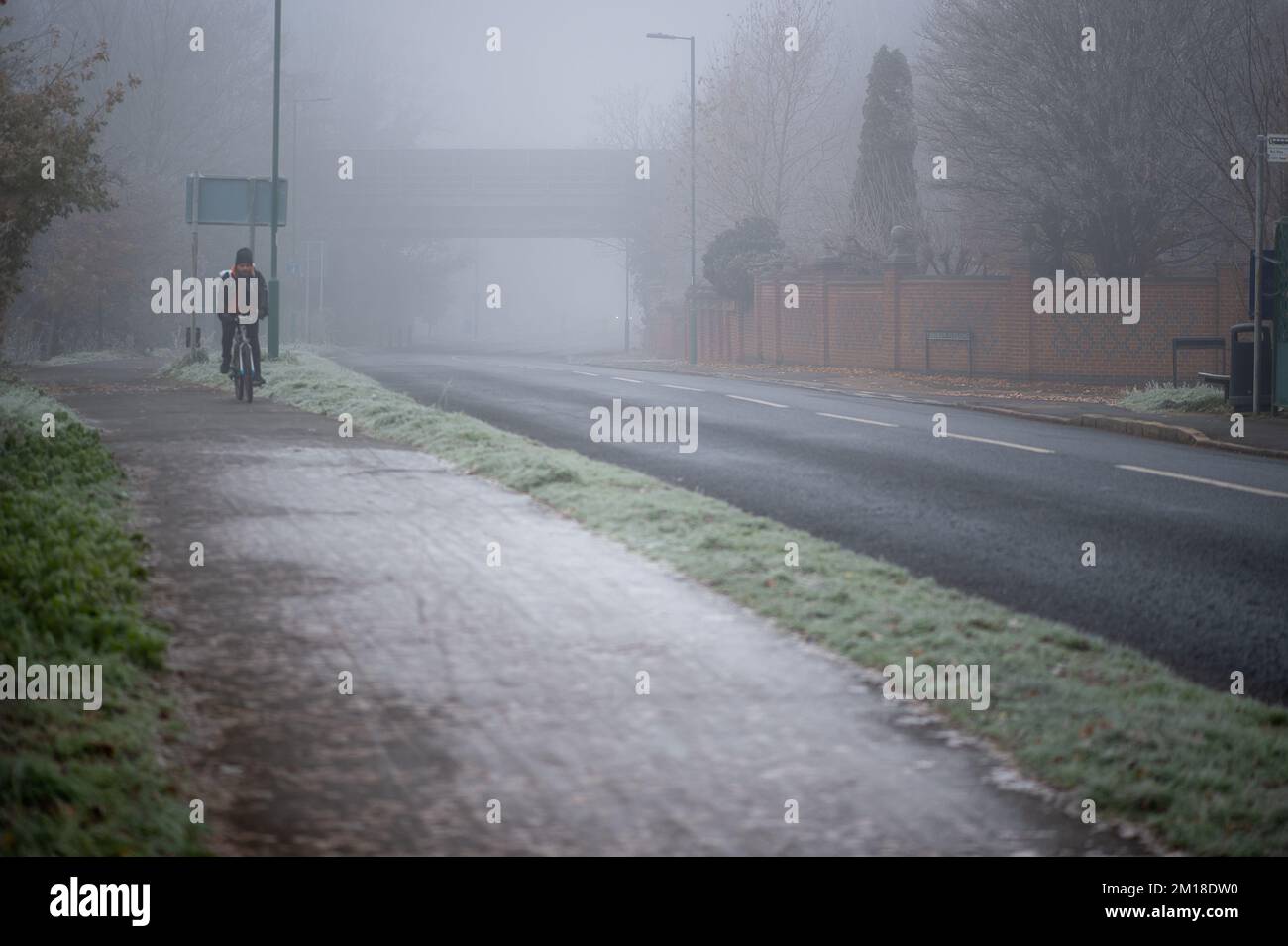 Eton, Windsor, Berkshire, UK. 11th December, 2022. A cyclist out in Eton this morning. A severe weather warning is currently in force with a warning for ice and fog. Credit: Maureen McLean/Alamy Live News Stock Photo