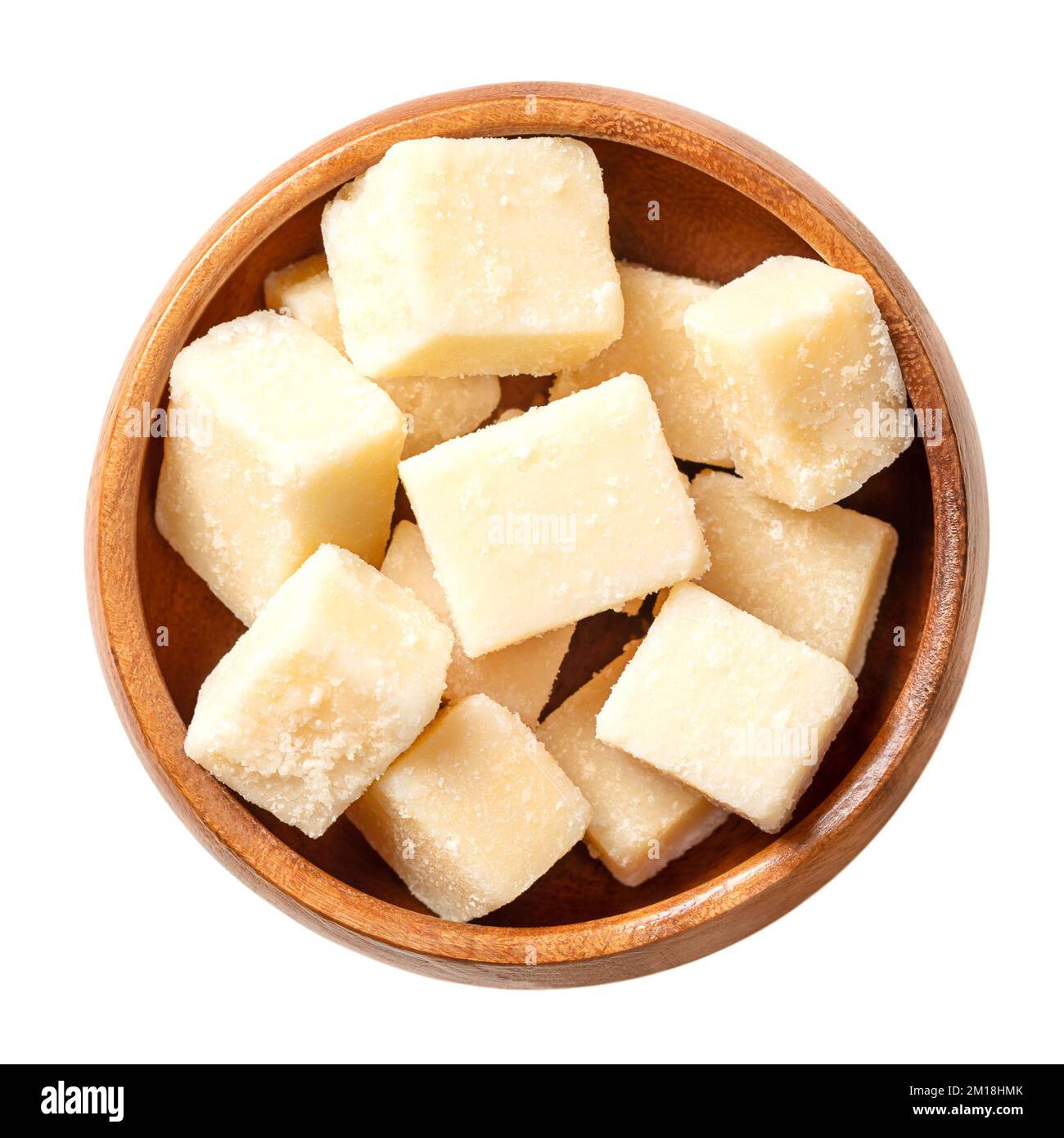 Grana Padano cheese cubes, in a wooden bowl. Italian hard cheese chunks, similar to Parmesan, crumbly-textured, with strong savory flavor. Stock Photo