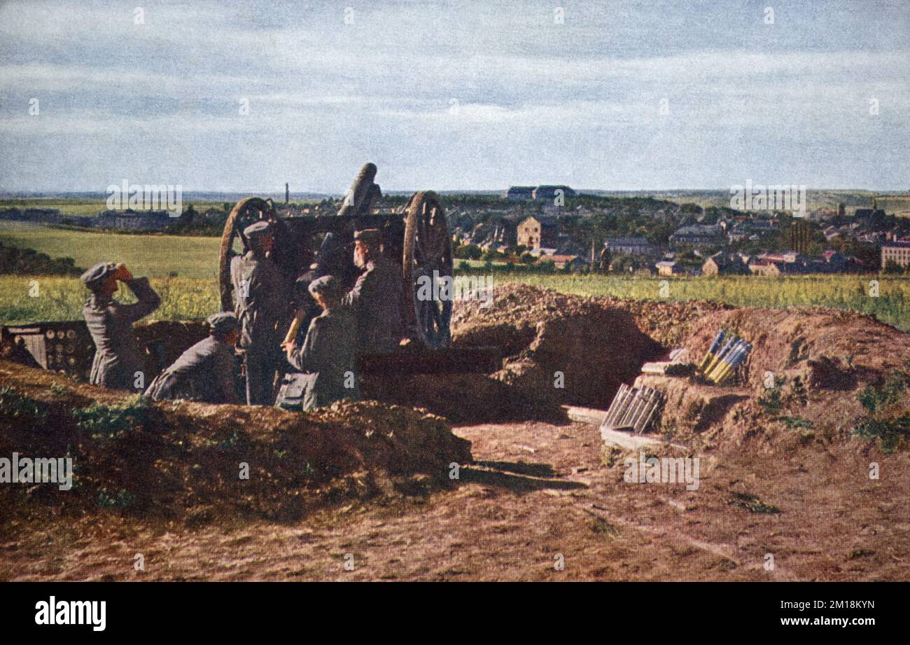 A rear view of a German army 7.7 cm Feldkanone 96 neuer Art  field gun in a firing position overlooking a French town on the Western Front during the First World War. From the German 3rd Army c.1915-1916. Stock Photo