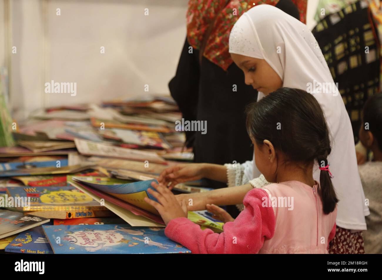 Karachi. 11th Dec, 2022. Children read at the Karachi International