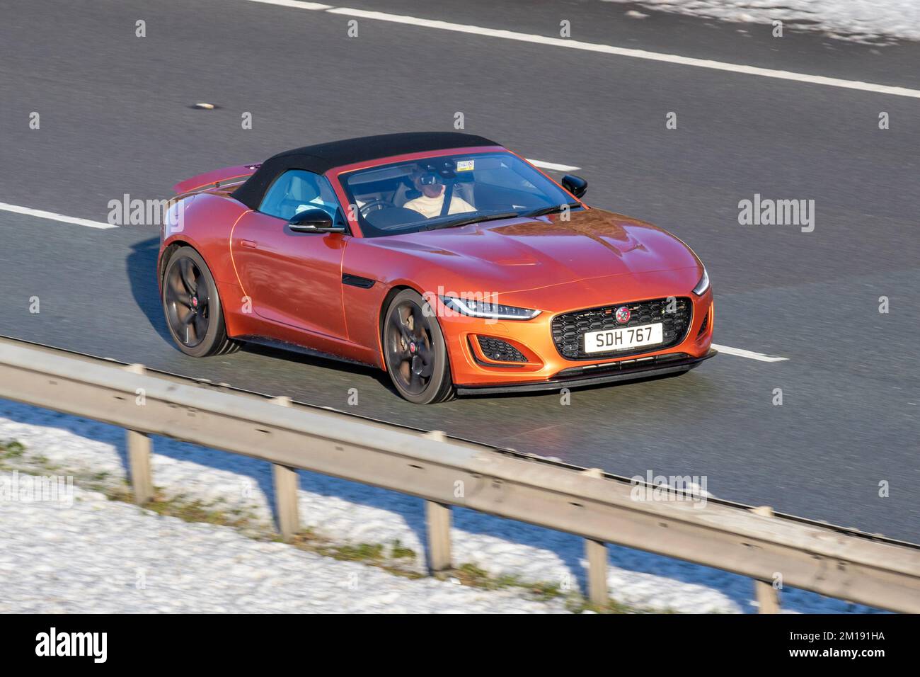 2022 Orange F-Type i4 R-Dynamic Auto, 1997cc Petrol 8-speed automatic; Frosted cars on a cold winter morning. Wintertime low temperatures with December frost and cold driving conditions on the M61 motorway, UK Stock Photo