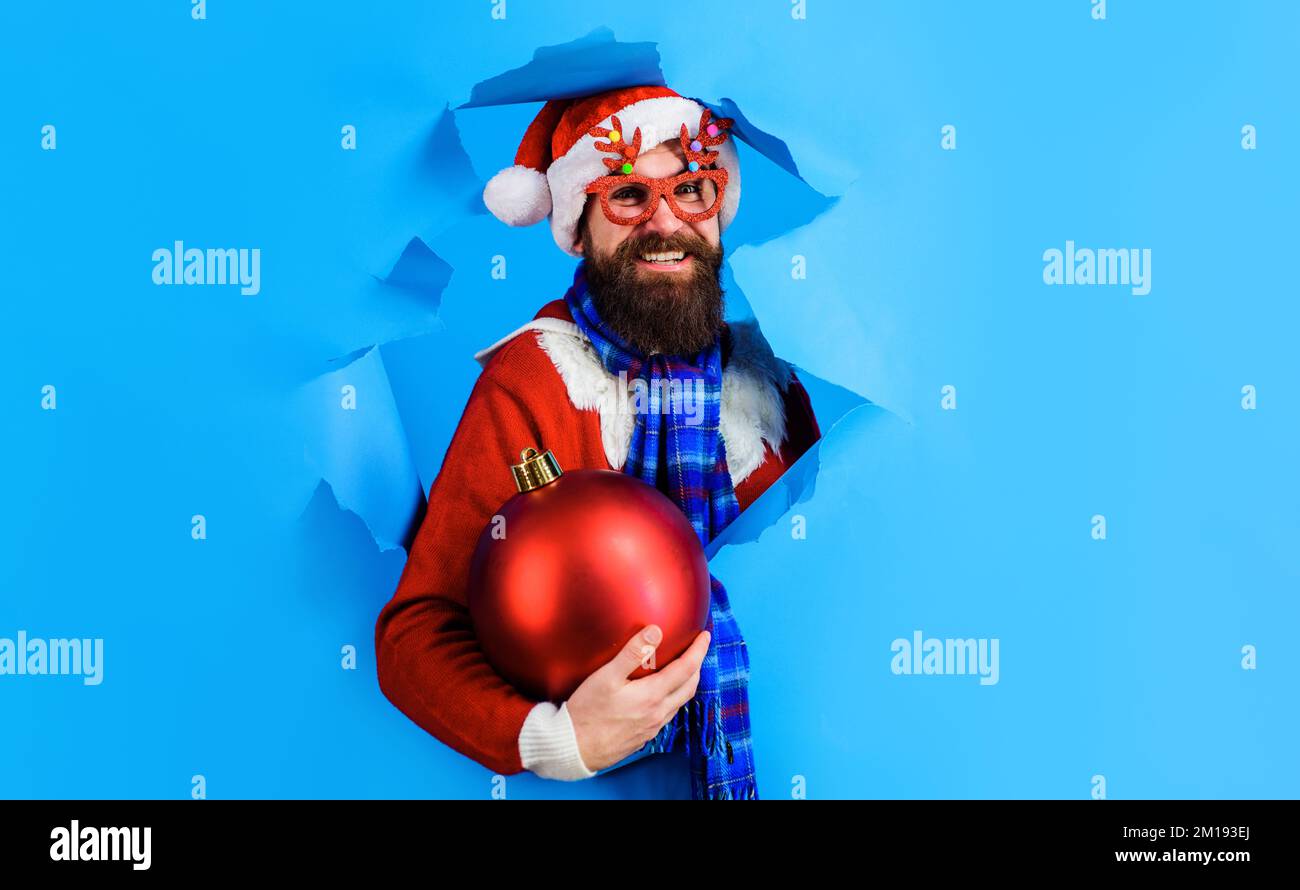Santa Claus with big christmas ball. Winter holidays. New year decorations. Discount. Season sale. Stock Photo