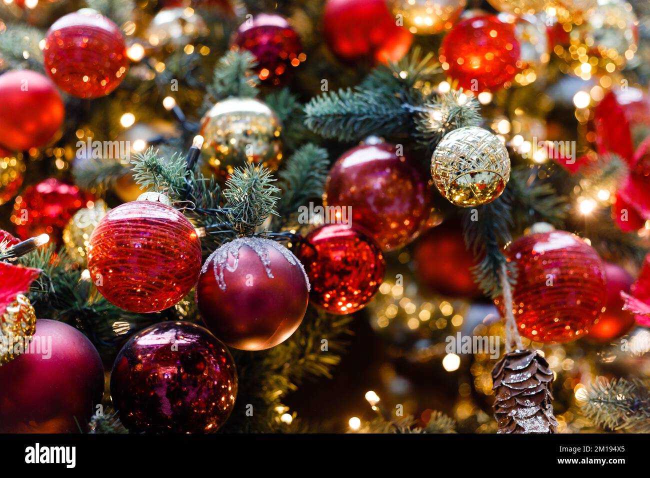 Close up of balls on christmas tree. Bokeh garlands in the background. New Year concept Stock Photo