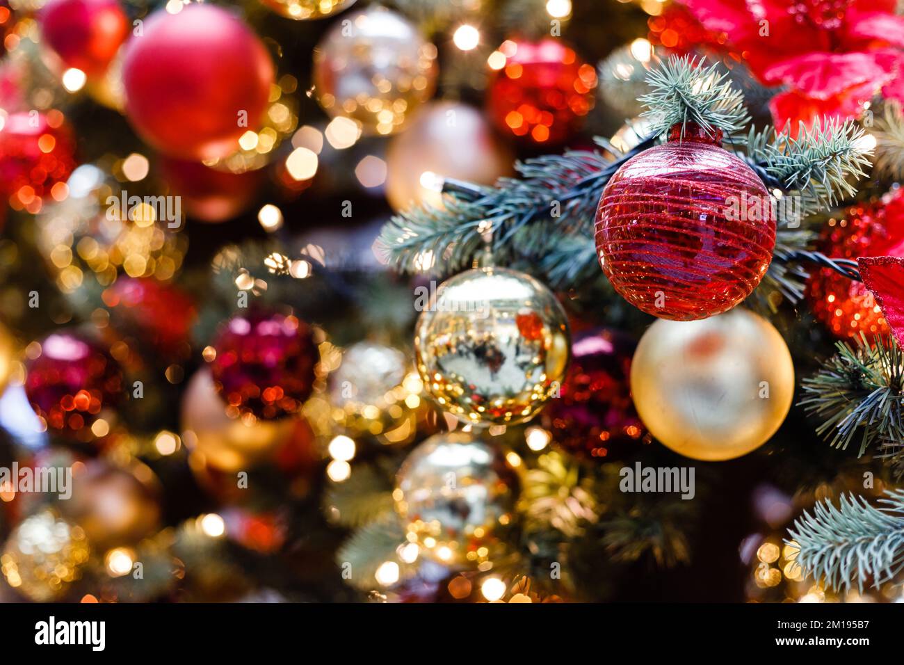 Close up of balls on christmas tree. Bokeh garlands in the background. New Year concept Stock Photo