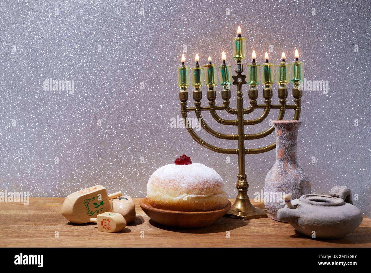 Jewish holiday Hanukkah background with menorah and dreidel with