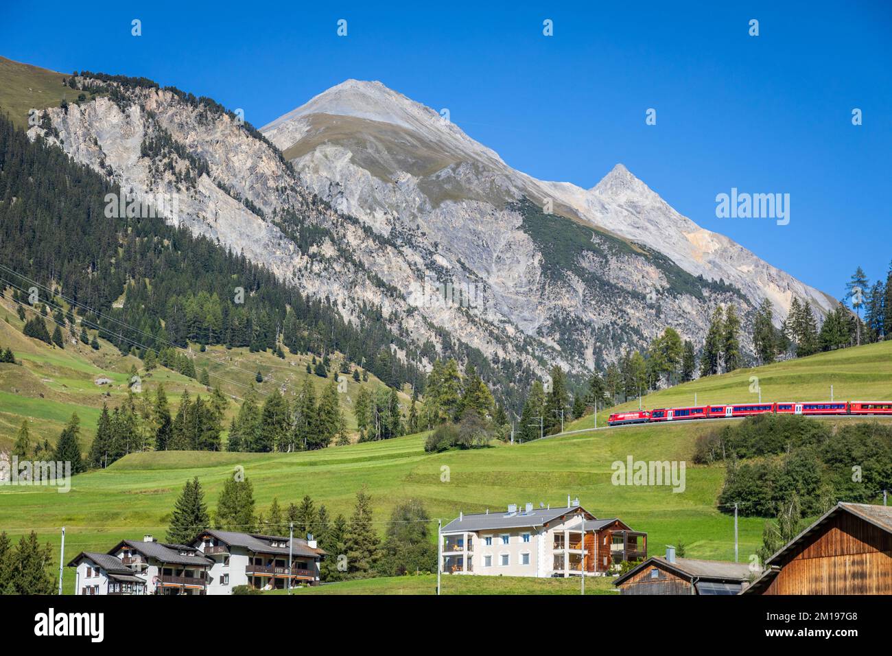Red Train and Preda village in the Swiss Alps, Switzerland Stock Photo