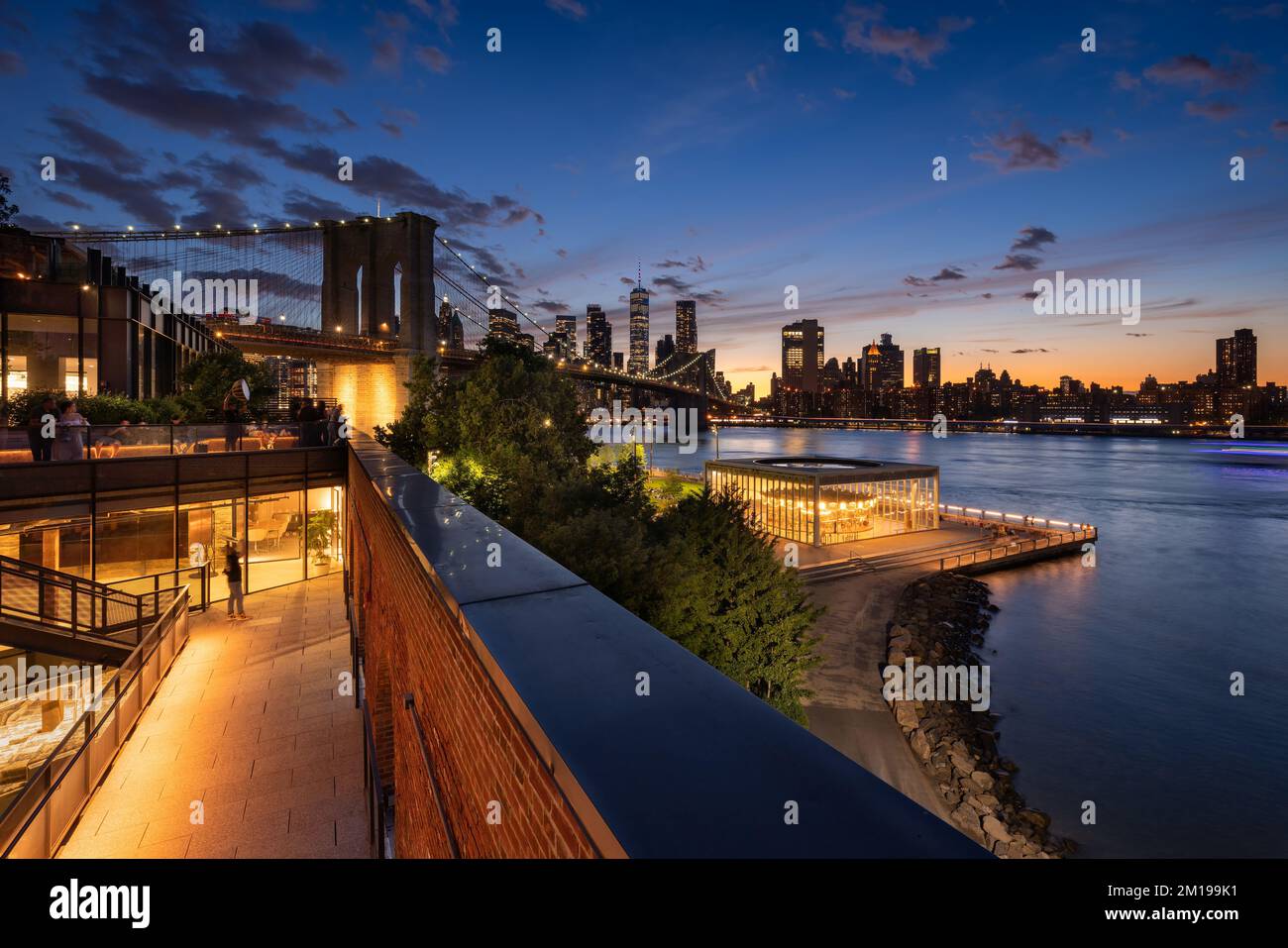 Evening view of the Brooklyn Bridge, Lower Manhattan skyscrapers from the Empire Stores shopping mall, DUMBO, Brooklyn, New York City Stock Photo