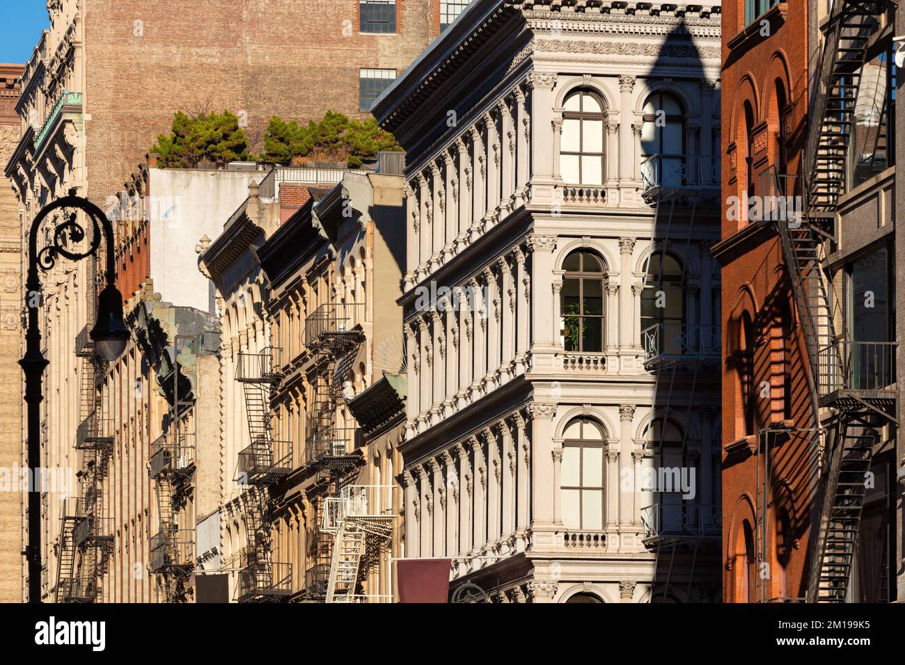 Cast iron facades of Soho loft buildings with fire escapes. Soho Cast
